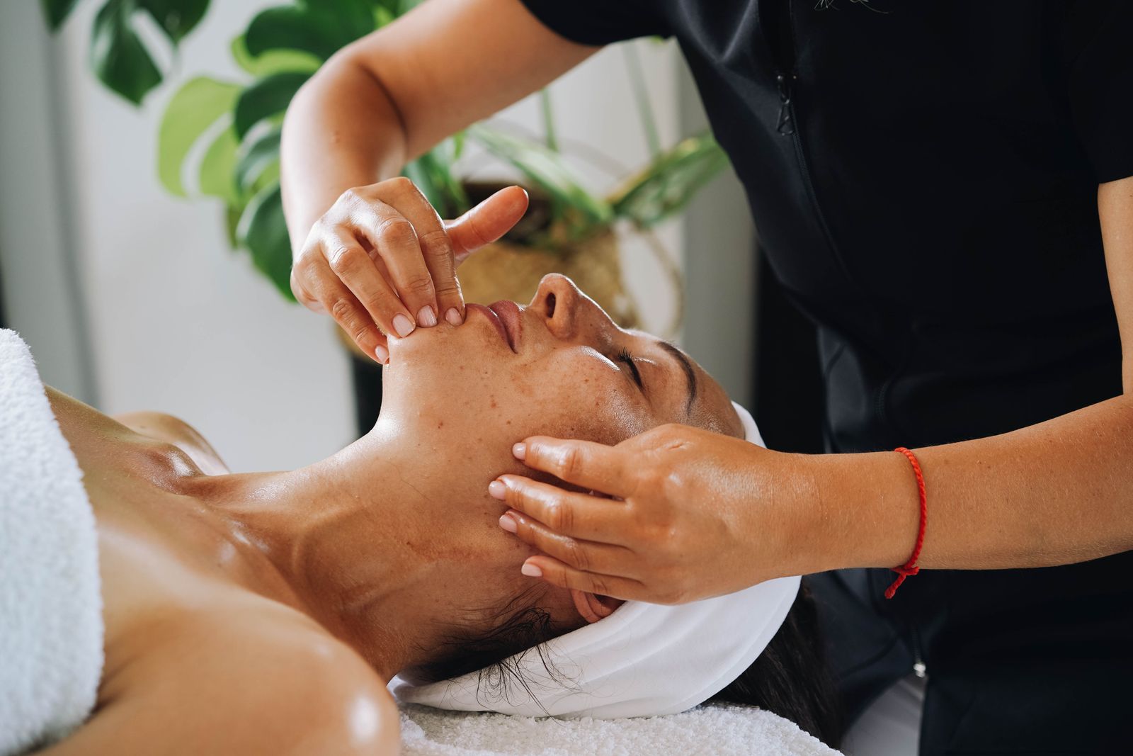 Calm, hands-on facial treatment in progress at the studio